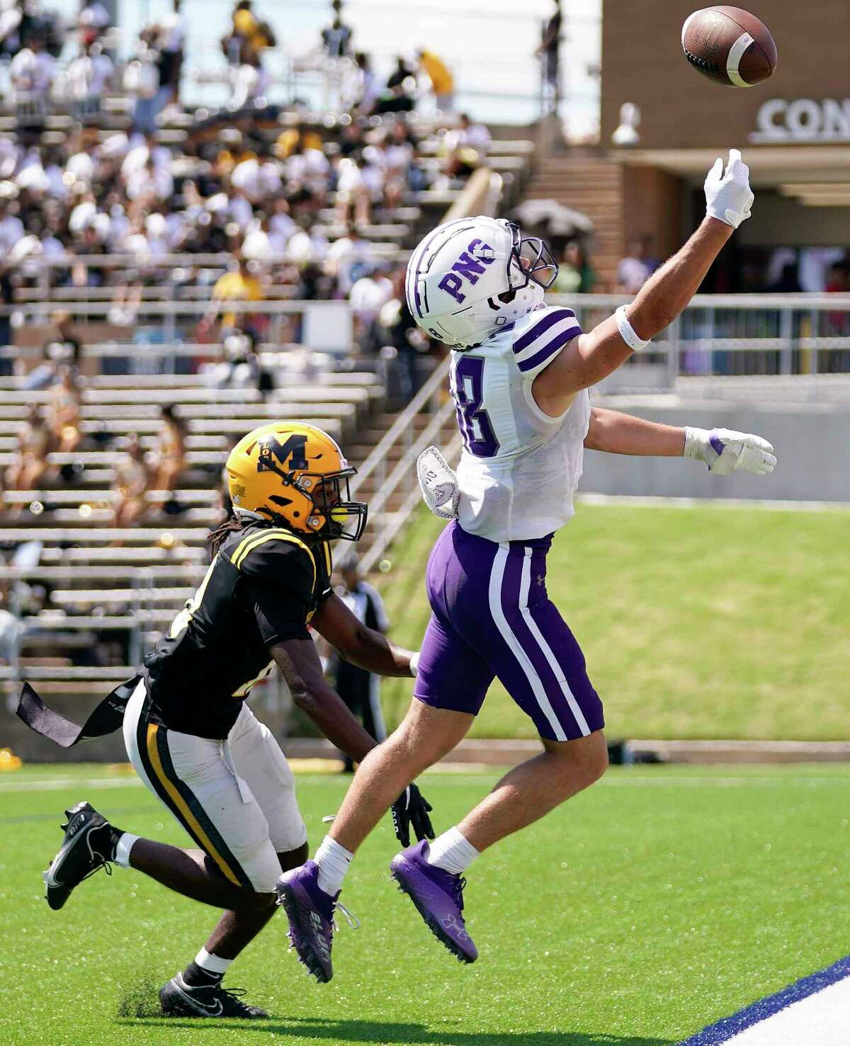 Port Neches-Groves wide receiver Chance Prosperie, right, misses a pass in the end zone as Marshall defensive back Ky Guillory defends during the first half of a high school football game, Saturday, Sept. 24, 2022, in Sugar Land, TX.