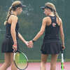 Jessa (left) and Brooklyn (right) Earnhart encourage each other during a doubles match against Rock Bridge on Friday at the EHS Tennis Center. 