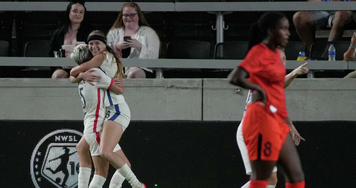 OL Reign players Bethany Balcer (8) and Megan Rapinoe (15) celebrate Balcer's goal against the Houston Dash during the first half of a NWSL match Saturday, Sept. 24, 2022, at PNC Stadium in Houston.