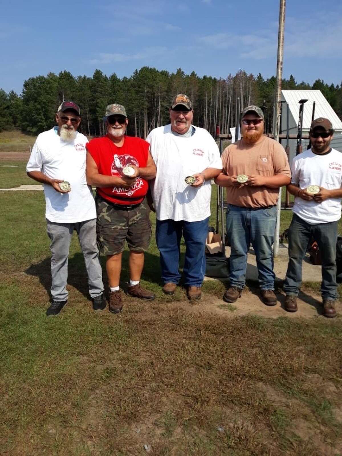 Reed City Sportsmen Club competed with 81 teams in the recent fall team shoot in Mason. The team in black shirts are:  left to right: Larry Holmes, Jackson Fox, Jim Gilchrist, David Magnuss and Jarrod Carpenter. Out of 500 targets they hit 489. The team with white/multi colored shirts are: left to right: Michael Adrianse, Terry Getts, Mark Curtis, Charles Miller and Seth Norman. The Chicken Pluckers took Class A fifth place. Out of 500 targets, they hit 472. 