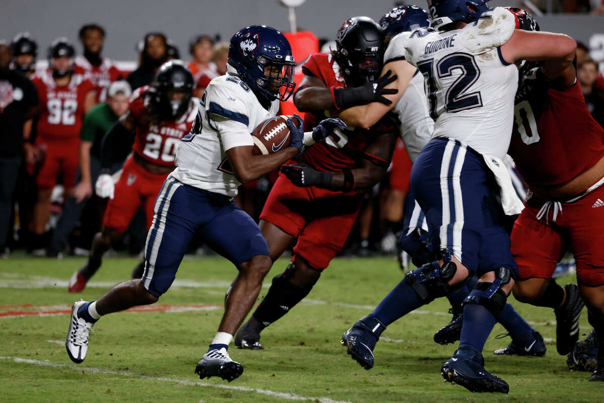 RALEIGH, NC - SEPTEMBER 24: Devontae Houston #25 of the Connecticut Huskies runs with the ball during the second half of their game against the North Carolina State Wolfpack at Carter-Finley Stadium on September 24, 2022 in Raleigh, North Carolina. NC State won 41-10. (Photo by Lance King/Getty Images)