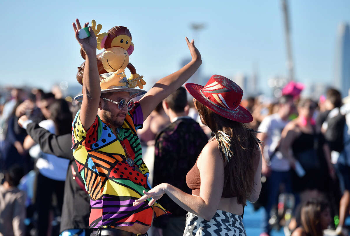 Joe Bernstein of Oakland, left, dances during the Avalanches' performance at Portola Music Festival on Saturday. 