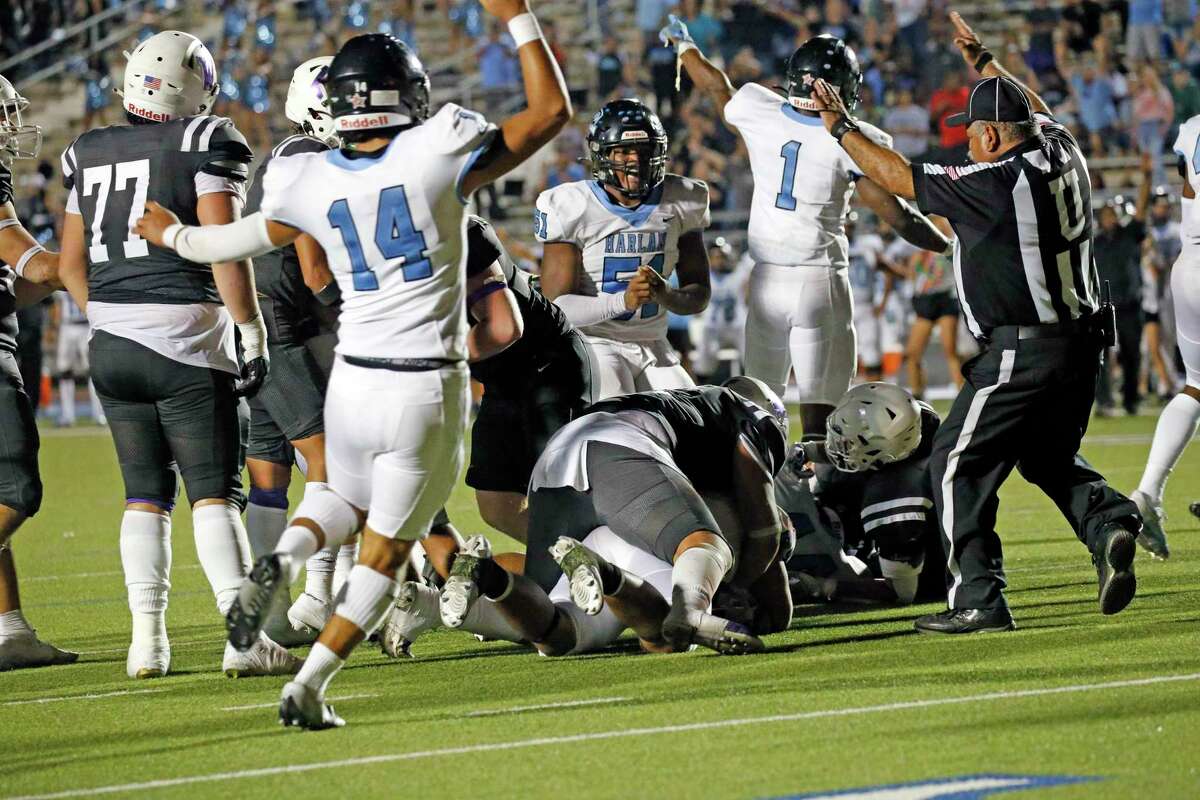 Harlan begins to celebrate after recovering a fumble in OT on Saturday, Sept. 24, 2020 at Gustafson Stadium Holmes defeated Warren 59-52 in OT.