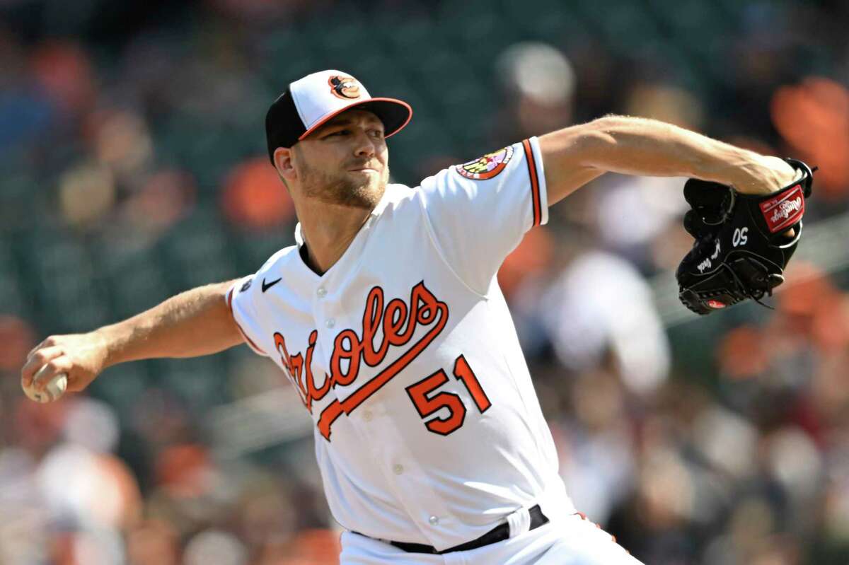 Baltimore Orioles pitcher Austin Both delivers against the Houston Astros in the first inning of a baseball game, Sunday, Sept. 25, 2022, in Baltimore. (AP Photo/Gail Burton)