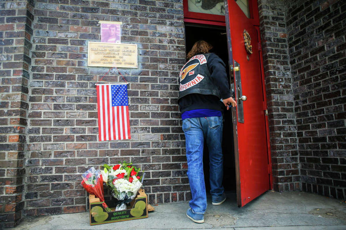 FILE: A Hells Angels member enters the club as a makeshift memorial in honor of Sonny Barger is set outside the Hells Angles Motorcycle Club Oakland chapter on Foothill Boulevard in Oakland, Calif., on Thursday, June 30, 2022. 