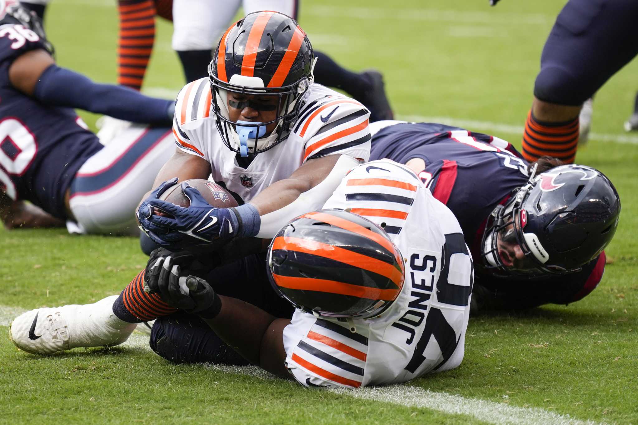 Chicago Bears tight end Cole Kmet is tackled by Houston Texans safety  Jonathan Owens during the second half of an NFL football game Sunday, Sept.  25, 2022, in Chicago. The Bears won