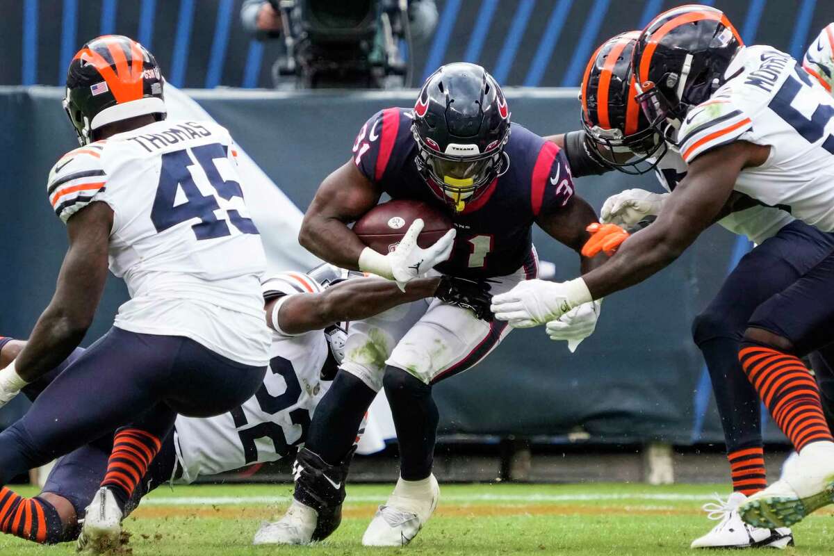 Houston Texans running back Dameon Pierce (31) is stopped at the line of scrimmage by Chicago Bears cornerback Kindle Vildor (22) and linebacker Nicholas Morrow (53)during the fourth quarter of an NFL football game Sunday, Sept. 25, 2022, in Chicago.