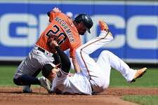 Houston Astros' Chas McCormick is tagged out by Baltimore Orioles second baseman Rougned Odor on a steal attempt in the third inning of a baseball game, Sunday, Sept. 25, 2022, in Baltimore.