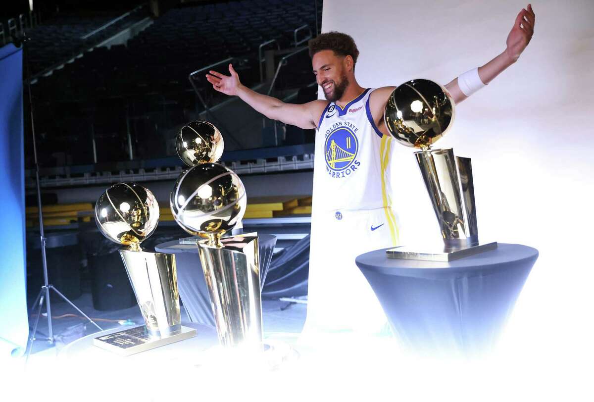 Golden State Warriors’ Klay Thompson poses with four Larry O’Brien trophies during Media Day at Chase Center in San Francisco, Calif., on Sunday, September 25, 2022.