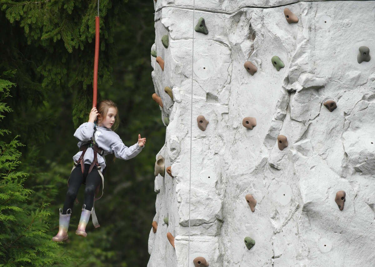 Rowan Herrmann, 6, of Glastonbury, rappels down a rock wall during Fall Family Fest Sundays at the Stamford Museum & Nature Center in Stamford, Conn. on Sunday, September 25, 2022. The children's event included a wall rock climbing, birds of prey program, live music, face painting, games, crafts and an apple slingshot.  Fall Family Fest continues October 2 and 9 from 10 a.m. to 2 p.m. with online pre-registration recommended.