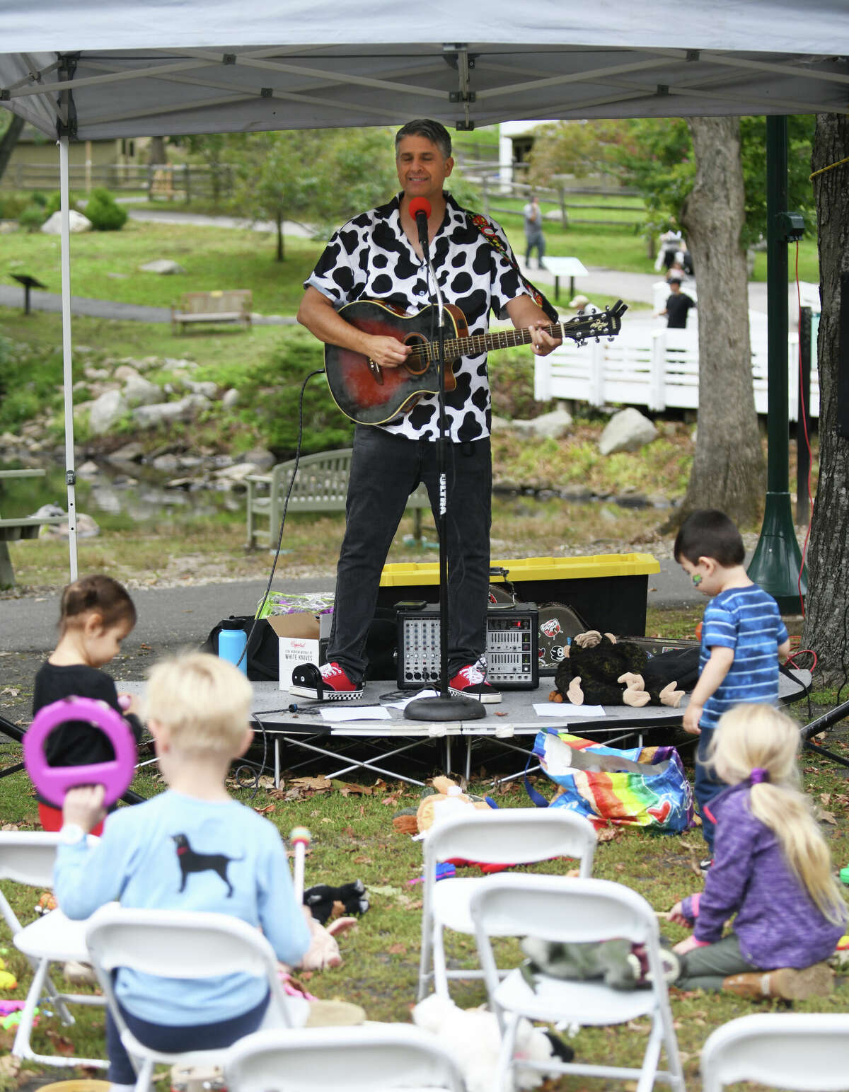 Tom Weber performs children's songs during Fall Family Fest Sundays at the Stamford Museum & Nature Center in Stamford, Conn. on Sunday, September 25, 2022. The children's event included a rock climbing wall, bird program of prey, live music, face painting, games, crafts and an apple slingshot.  Fall Family Fest continues October 2 and 9 from 10 a.m. to 2 p.m. with online pre-registration recommended.
