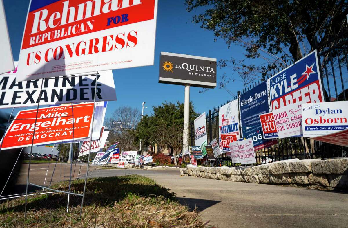 Campaign signs line the sidewalk outside of a primary voting location at a La Quinta on the West 610 Loop, Tuesday, March 1, 2022, in Houston.