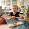 5-year-old Emma Richards poses at the Milford Library, in Milford, Conn. Sept. 26, 2022.