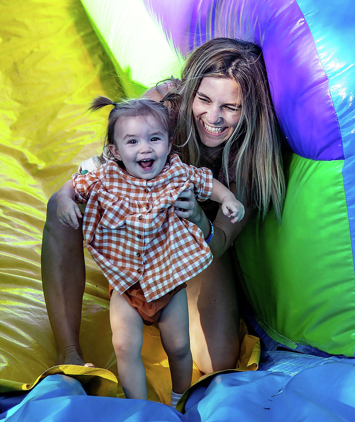 Kids and parents alike enjoy the inflatable slides and bouncy houses provided for their entertainment at The Kingwood Oktoberfest.