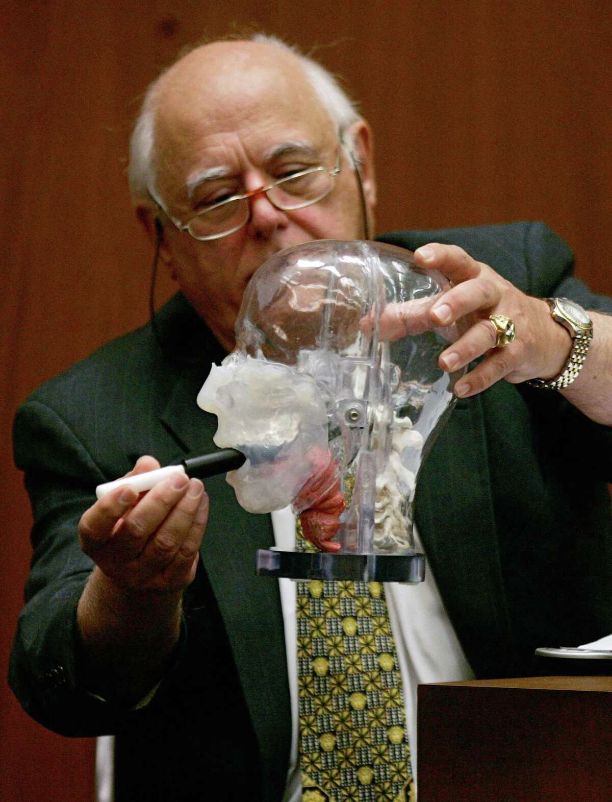PhD. Gunshot wound forensic expert Vincent Di Maio (right), who testified for the defense during the murder trial of music producer Phil Spector, introduced a plastic stick to show the mouth of a plastic head model Internal self-oral gunshot wound Wednesday, June 27, 2007, Los Angeles.  Spector is accused of killing actress Lana Clarkson in February 2003.  (AP Photo/Damian Dovarganes, Poland)