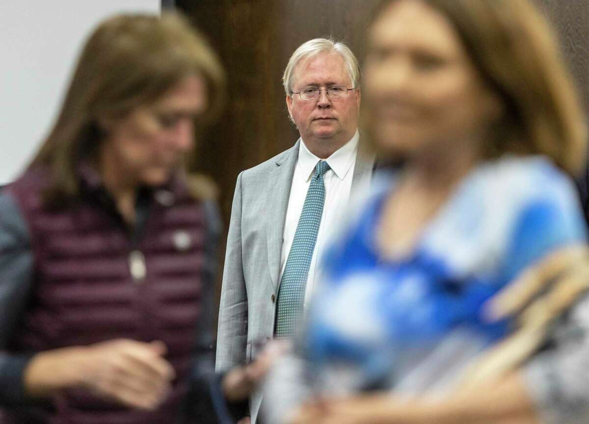 Graham Weston, center, watches his wife, Elizabeth, left, leave the courtroom Monday, Sept. 26, 2022 in the Comal County Courthouse Annex in New Braunfels after the jury was sent to the jury room to begin deliberations in the Westons’ divorce trial.