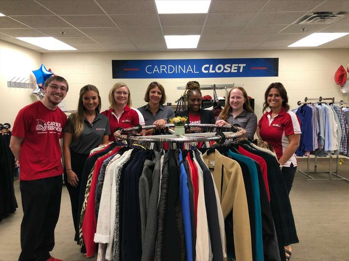 The staff of Saginaw Valley State University's Career Services office stands in the new Cardinal Closet, a new program that supports students with free professional attire. 