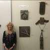Sculptor Lucy Krupenye poses with her art. 
