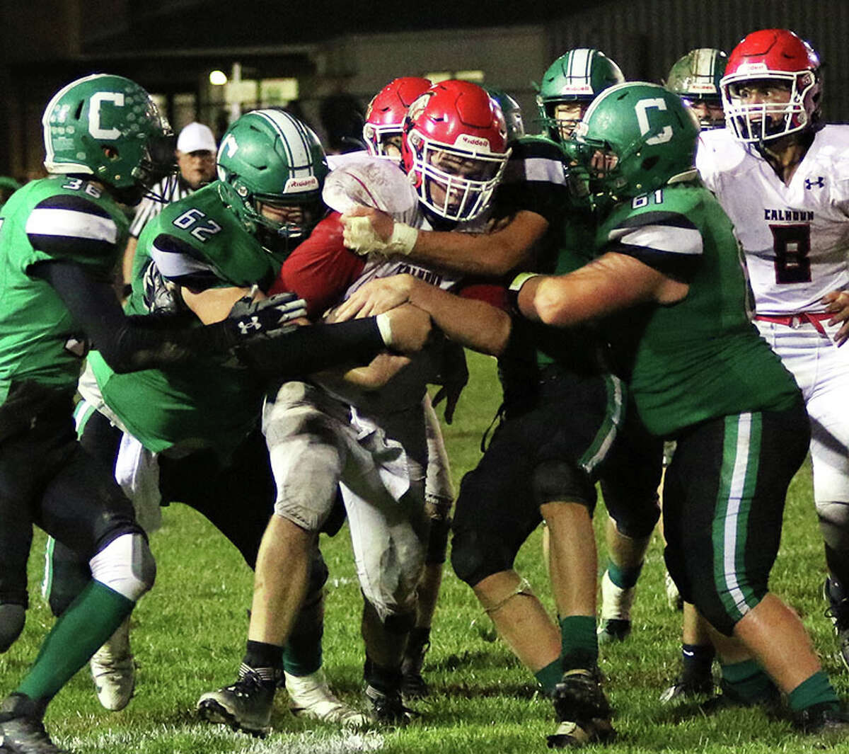 Calhoun's Conner Longnecker (middle) scored on a 54-yard touchdown run Friday, but the Warriors fell to Beardstown 36-11. Longnecker is shown in previous action against Carrollton.