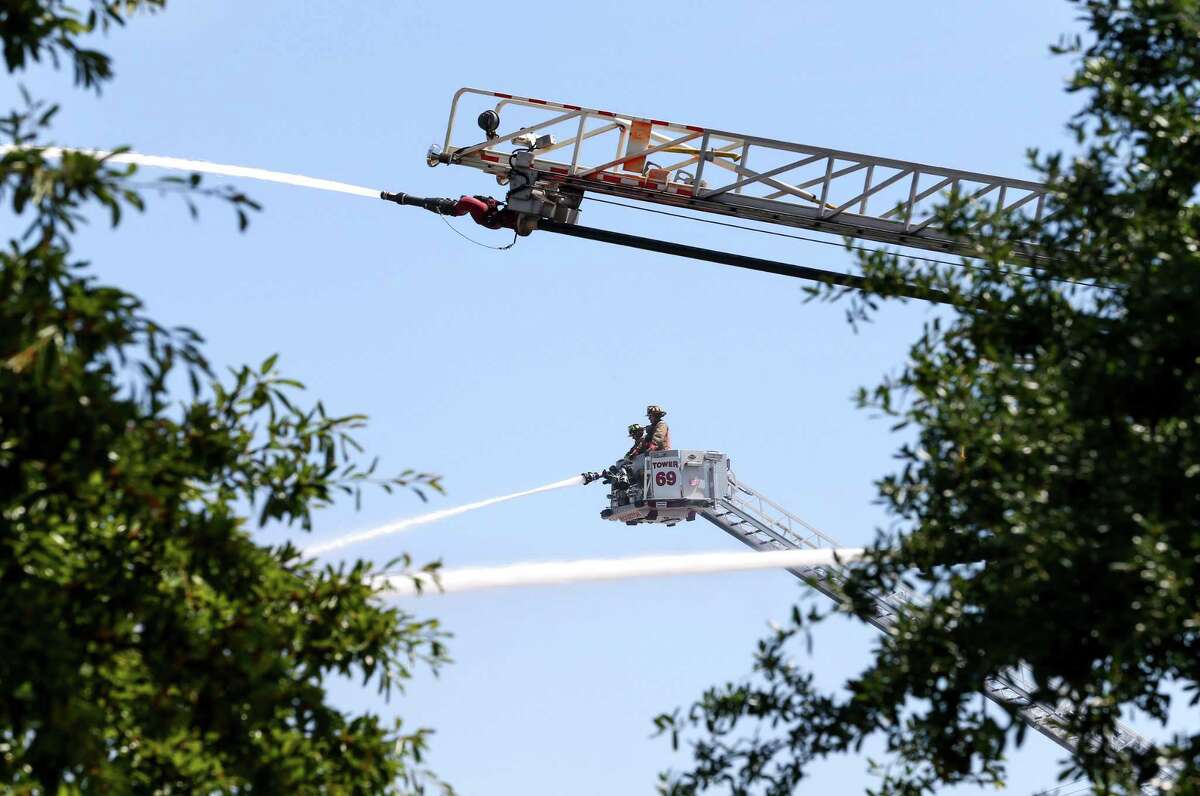 Firefighters battle a four-alarm fire in the 1700 block of Laverne, Thursday, May 5, 2016, in Houston. Firefighters, like other Houston city employees, can make extra money working overtime.