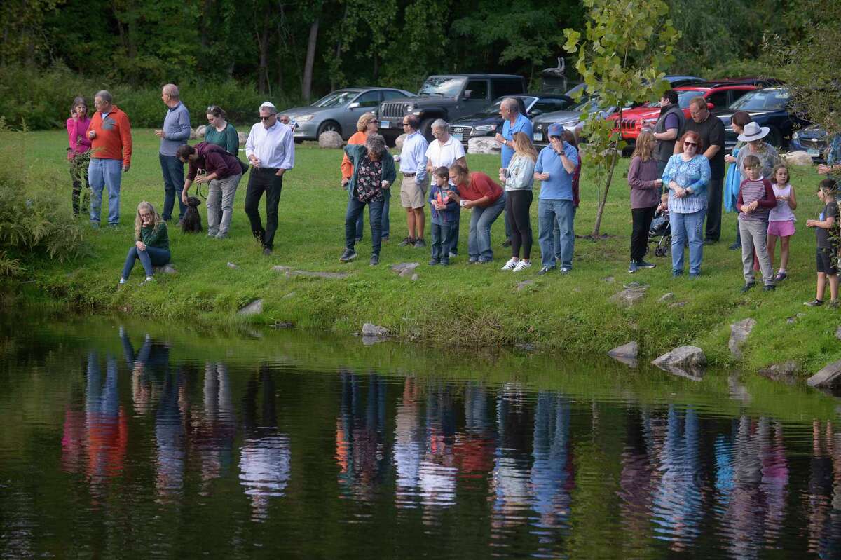 The United Jewish Center in Danbury held a Tashlich service in Bennett Memorial Park, in Bethel, for Rosh Hashanah, on Monday, September 27, 2022. During the ceremony, worshipers symbolically cast off their sins from the previous year by traditionally throwing bread crumbs into flowing water. The Center changed to bird seed to be more environmentally friendly.