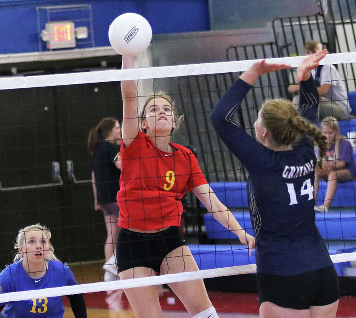 Roxana's Abby Gehrs (9) hits past a Father McGivney block in a match at the Roxana Tourney in August. On Monday, Gehrs had three kills in the Shells' win at Southwestern.