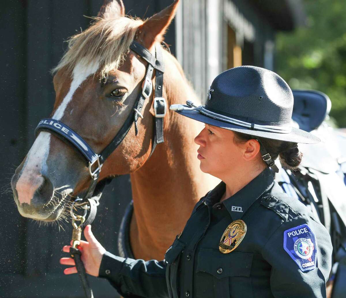 Conroe Police Officer Shana House prepares her horse to go out on patrol as part of the department’s newly-formed mounted patrol unit go out for the day, Tuesday, Sept. 27, 2022, in Conroe. The unit, with five full-time officers, provides horse-back police patrols in both neighborhoods, residential, and business areas in Conroe.