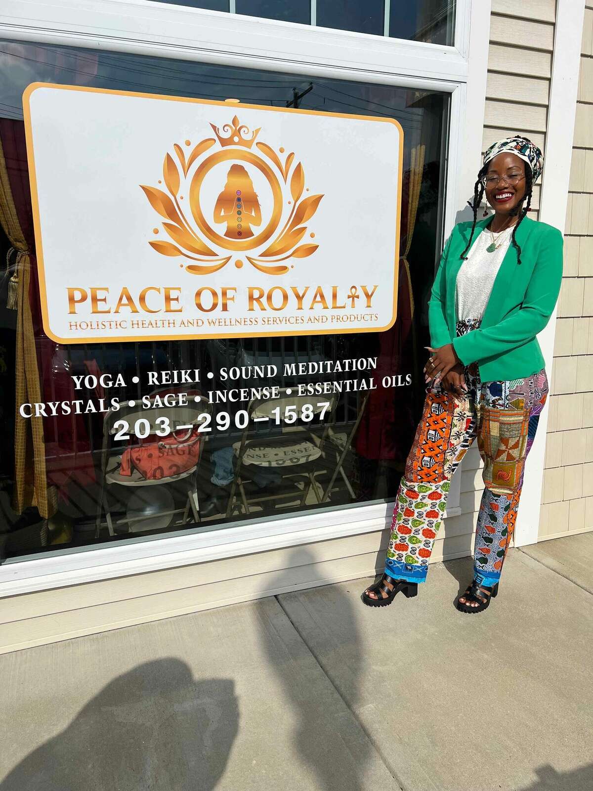 Vernatha Montoute stands in front of her studio, Peace of Royalty, during the grand opening on Sept. 25 in Walnut Beach.