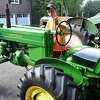 Andrew Hanna, 17, starts up his restored 1942 John Deere Model M at his home in Greenwich, Conn. Monday, Sept. 26, 2022. Hanna has amassed more than 230,000 followers on TikTok on his account @thesmallenginekid in which he repairs and restores old, broken tractors. The Greenwich High School student is self-taught and currently has 10 tractors, ranging from 1937 to 1952, that he has fully restored or is in the process of repairing and restoring.