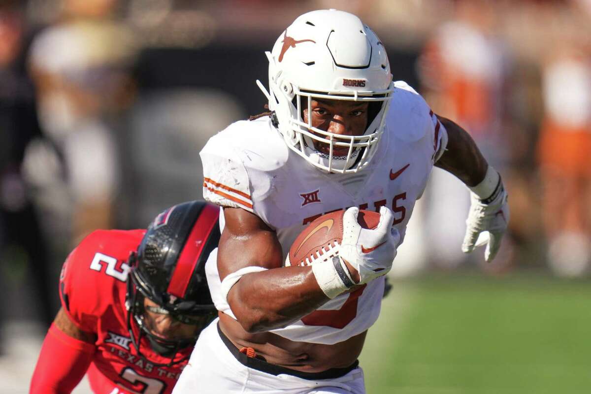 Bijan Robinson, running for a touchdown against Texas Tech, later suffered a key fumble but is keeping his eyes looking forward