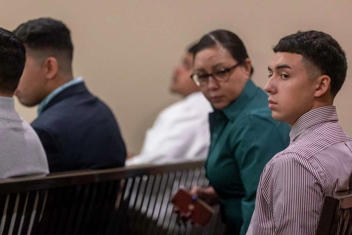 Jarren Diego Garcia, 20, sits with his family on the first day of his trial Tuesday. Garcia is accused of fatally shooting his stepfather, Mark Ramos, on March 5, 2021. San Antonio police said Garcia admitted to shooting his stepfather after he threw a speaker at Garcia and threatened his mother. Garcia faces up to life in prison.