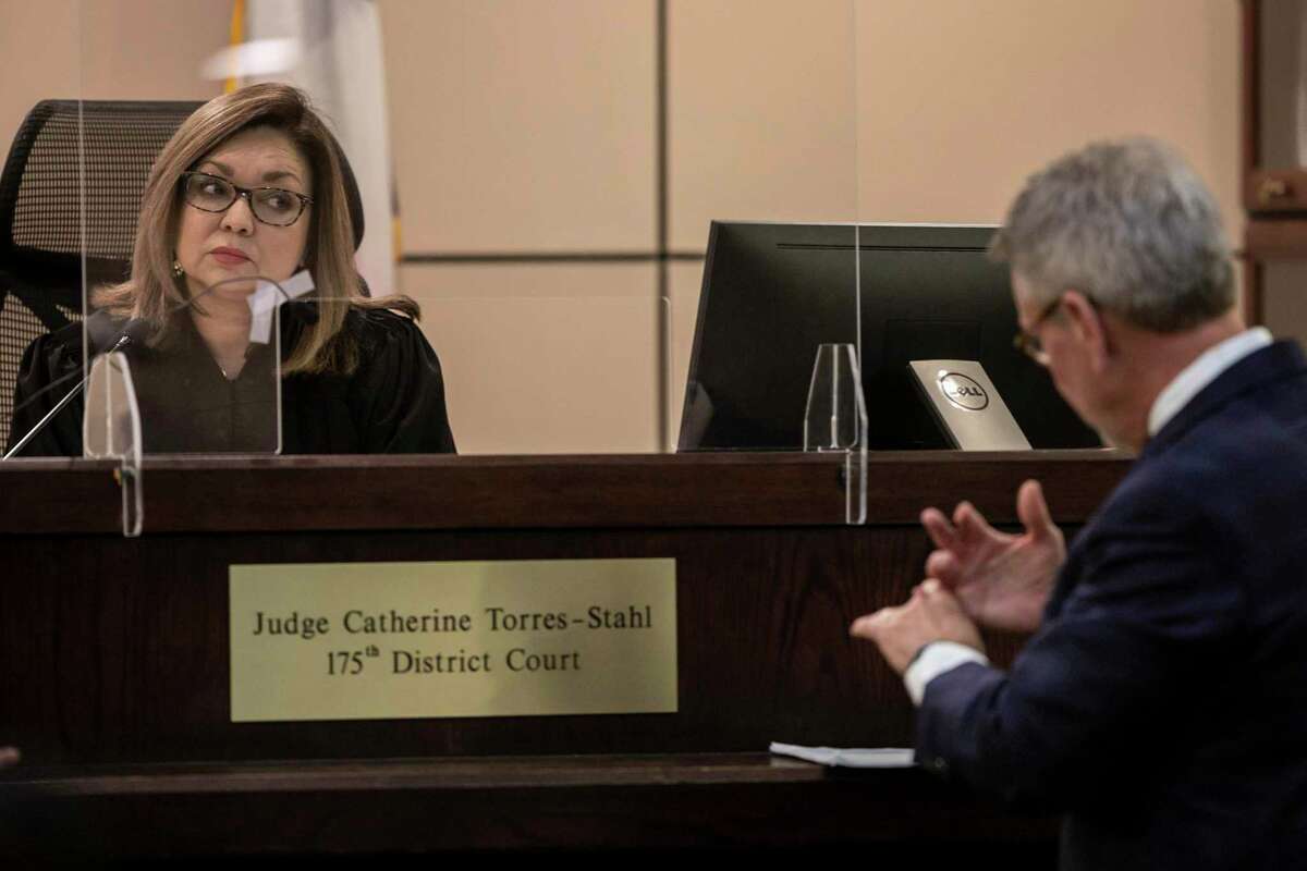 State District Judge Catherine Torres-Stahl, left, talks with defense attorney Charles Banker, right, on Tuesday at the murder trial of Jarren Diego Garcia, 20, accused of fatally shooting his stepfather Mark Ramos in 2021.