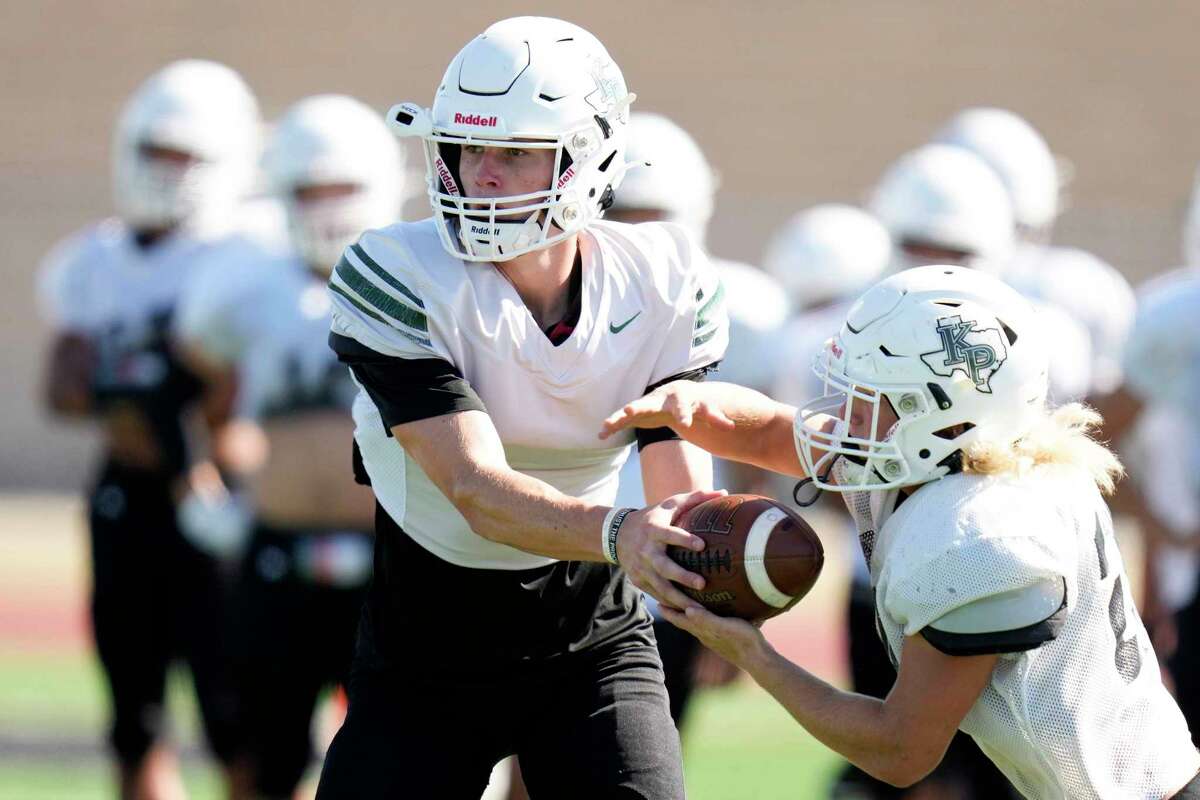 Kingwood Park quarterback Patrick Overmyer, handing off to running back Brayden Moronko during Tuesday's practice, has been a threat with his arm and legs this season.