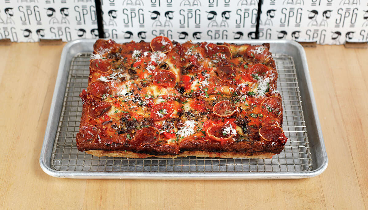The King’s Pie is a Detroit-style pizza with mushrooms, pepperoni, red sauce, pickled peppers, and hot honey.