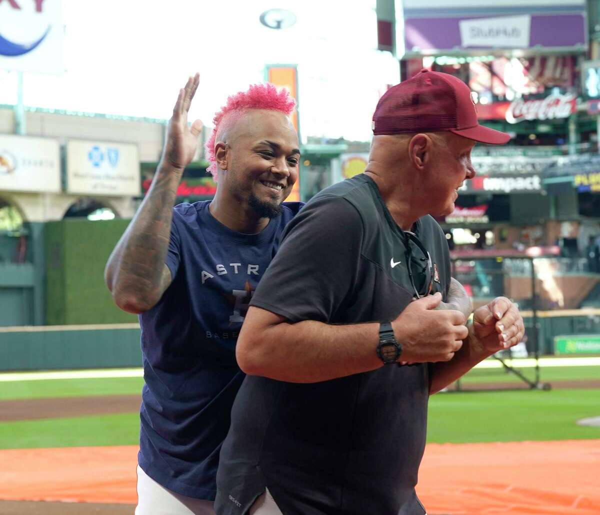 Astros catcher Martín Maldonado, left, enjoys a playful moment with former Houston pitching coach Brent Strom, who was back at Minute Maid Park on Tuesday with the Arizona Diamondbacks. 
