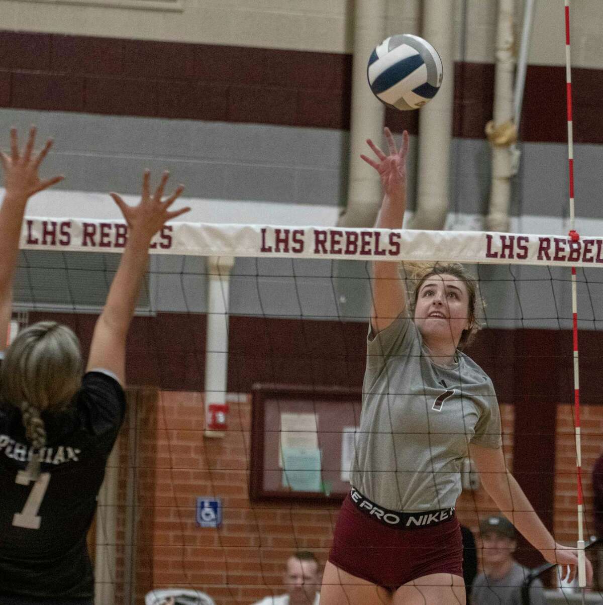 Legacy High's Kendall Harrington tips the ball away from the reach of Permian's Anahi Orona 09/27/2022 at Legacy High gym. Tim Fischer/Reporter-Telegram