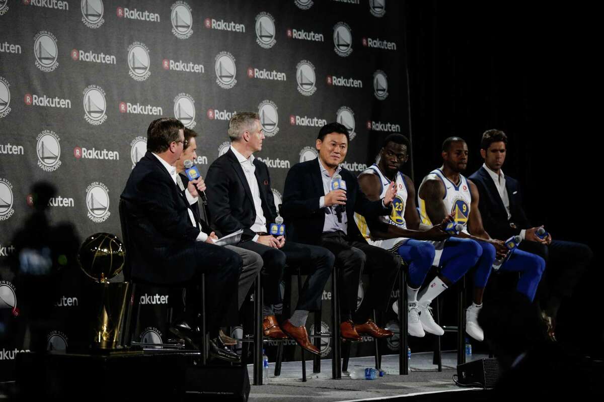 Rakuen CEO Hiroshi "Mickey" Mikitani (center) speaks during a press conference to announce a jersey sponsorship deal between Rakuten and the Golden State Warriors in Oakland, Calif., on Tuesday, Sept. 12, 2017.