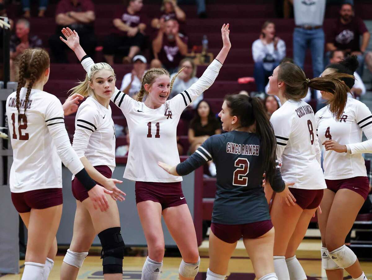 Cinco Ranch’s Kassidy O’Brien (11) celebrates with her teammates after a winning point during the District 19-6A high school volleyball game between the Cinco Ranch Cougars and the Katy Taylor Mustangs at Cinco Ranch High School in Katy, TX on Tuesday, September 27, 2022.