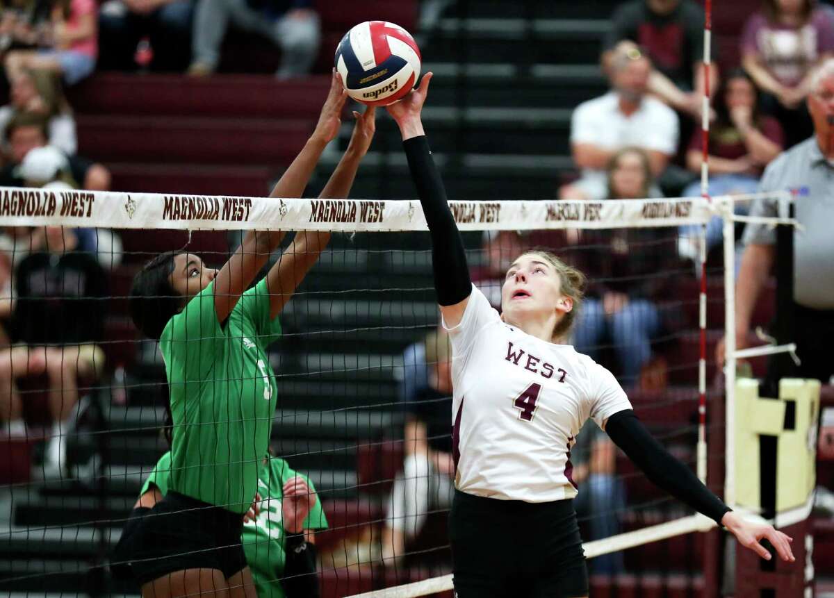 Magnolia West's Bethany May (4) contests the ball at the net against Brenham's Tiyana Jones (5) in the second set of a District 21-5A high school volleyball match at Magnolia West High School, Tuesday, Sept. 27, 2022, in Magnolia.