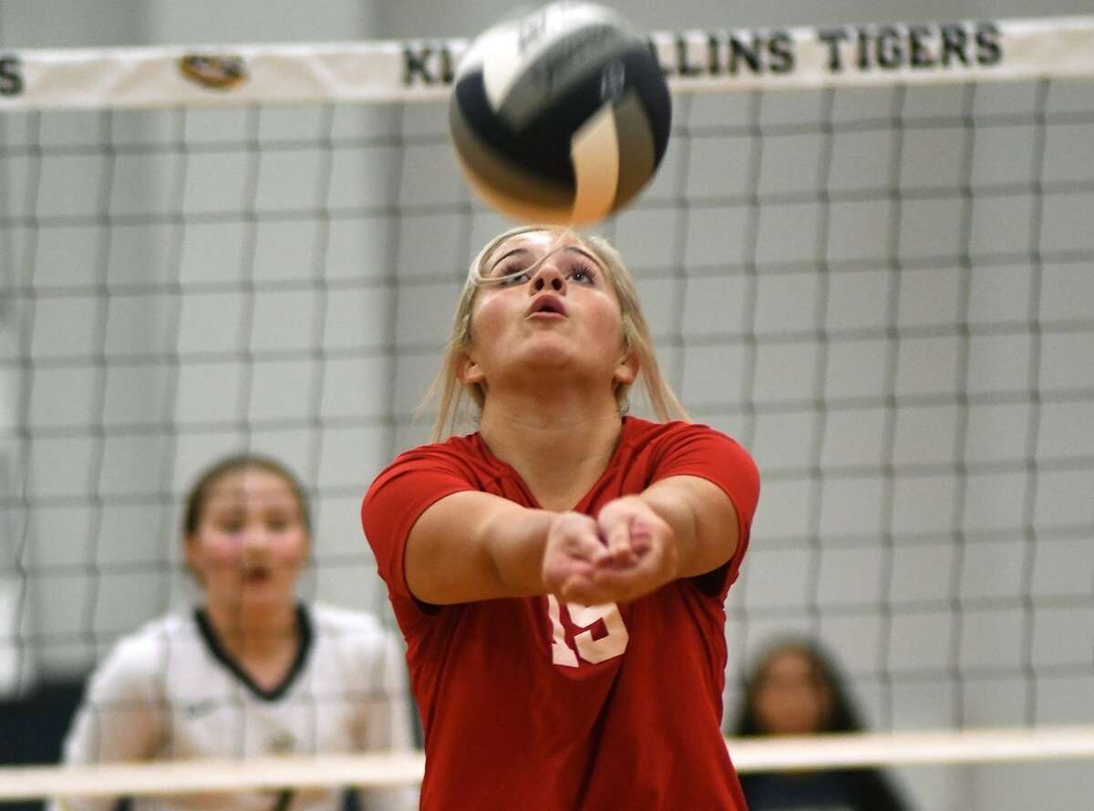 With her back to the net, Tomball senior setter Madalyn Hoot hits a return against Klein Collins on Tuesday night.