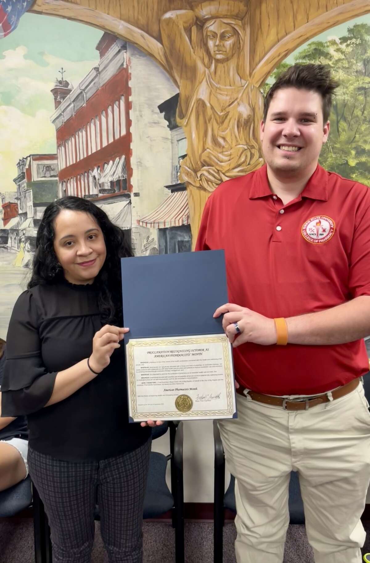 Ferris State University Pharmacy students Maria Gonzales (left) and Jordan Hiltunen (right) were presnted with a proclamation recognizing October as American Pharmacists' Month during a recent city commission meeting.