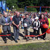 Mayor Mark Lauretti cuts a ribbon during a ceremony for a new playground at Sunnyside Elementary School, in Shelton, Conn. Sept. 27, 2022.