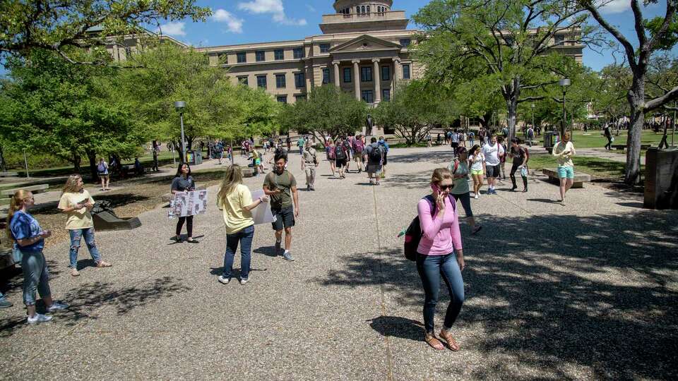 Students walk by the Academic Building between classes at Texas A&M University, Thursday, March 23, 2017, in College Station.