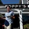 Dave Oricchio, owner of Poppy's Coffee + Kitchen, brings breakfast to customers at an outside table of the eatery on Whitney Avenue in New Haven on September 28, 2022.