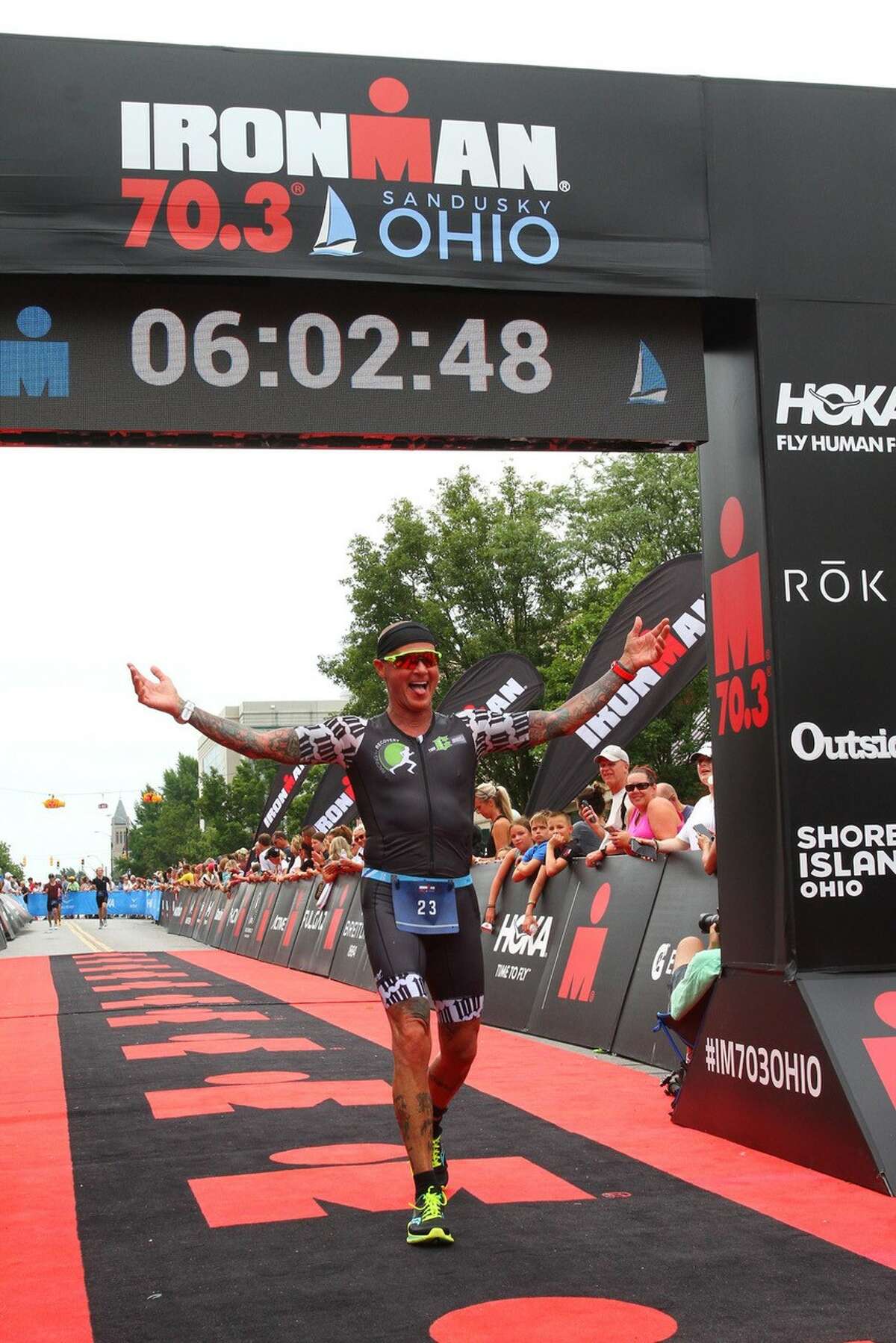 Todd Crandell crosses the finish line during an Ironman Triathlon competition.