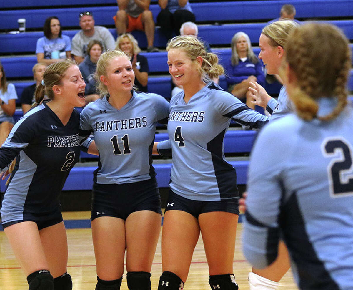 Jersey's Taylor Stelbrink (2), Lauren Lyons (11) and Kari Krueger (4) celebrate a point with teammates in a match against CM earlier this season at the Roxana Tournament. On Tuesday, Krueger's 12 kills led the Panthers to a three-set win over CM in a MVC match in Jerseyville.
