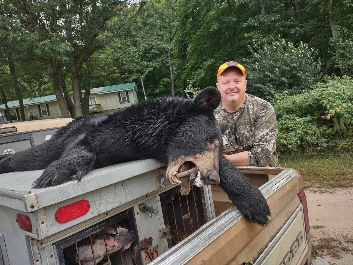 Big Rapids' Ben Montgomery shows the rewards of his first successful bear hunt.