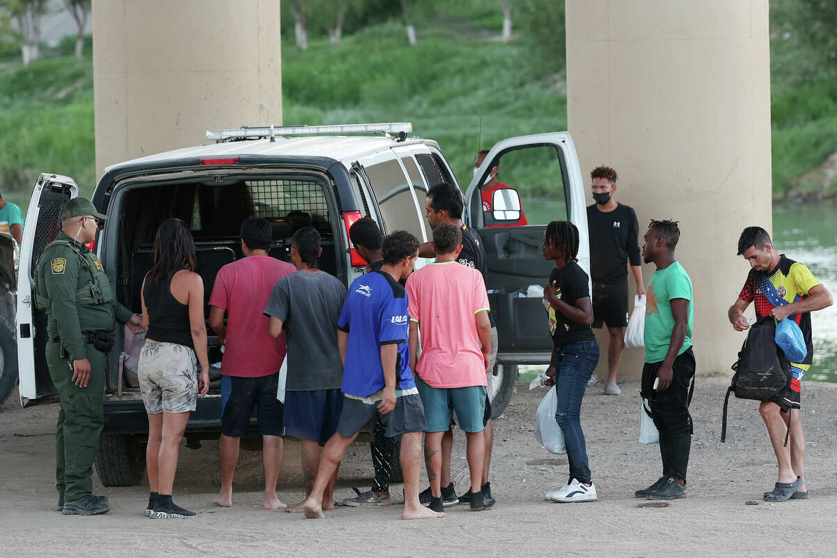 After surrendering to Texas National Guard, migrants are loaded into a U.S. Border Patrol van by the Camino Real International Bridge in Eagle Pass, Texas, Tuesday, Sept. 20, 2022. A surge of migrants crossing has been seen in the area. Texas Gov. Greg Abbott started busing migrants from South Texas to Chicago in late August in response to what he called a lack of federal government action on the border issue. 