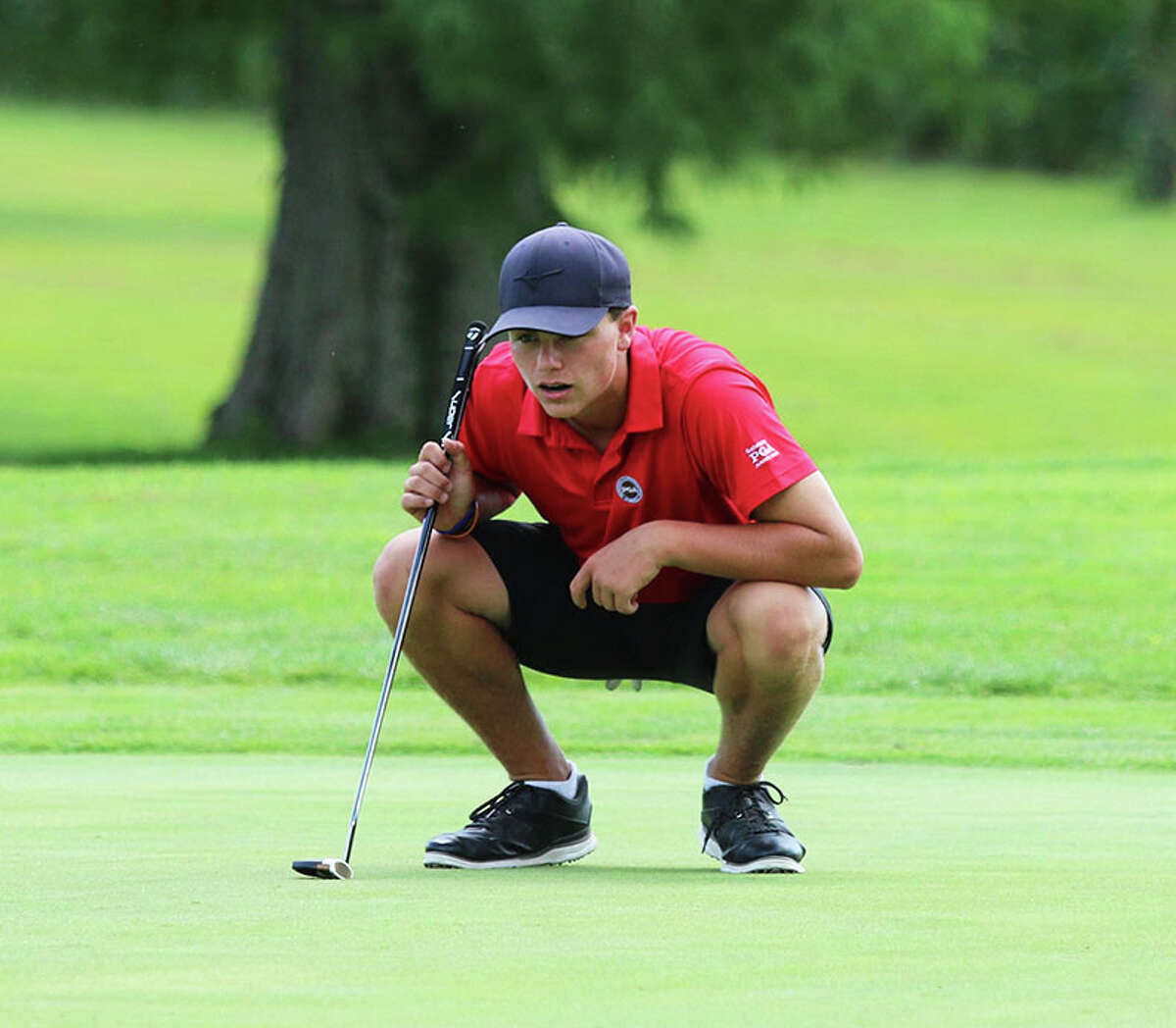 Alton's Sam Ottwell, shown lining up a putt in the Madison County Tourney in Augusta at Belk Park, was runner-up Wednesday at the Quincy Class 3A Regional to help the Redbirds finish third and advance as a team to the sectional for the first time since 20001.