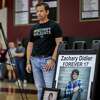 Chris Didier listens as his wife, Laura, speaks to a gymnasium full of students during an assembly bringing attention to deaths caused by fentanyl Wednesday at Whitney High School in Rocklin (Placer County). The Didiers lost their son, Zach, then 17, to a fentanyl overdose in December 2020.